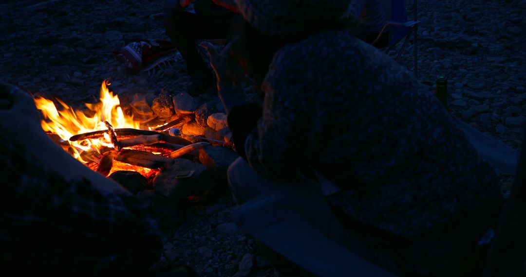 People Enjoying Warmth from Campfire at Night in Cozy Outdoor Setting - Free Images, Stock Photos and Pictures on Pikwizard.com