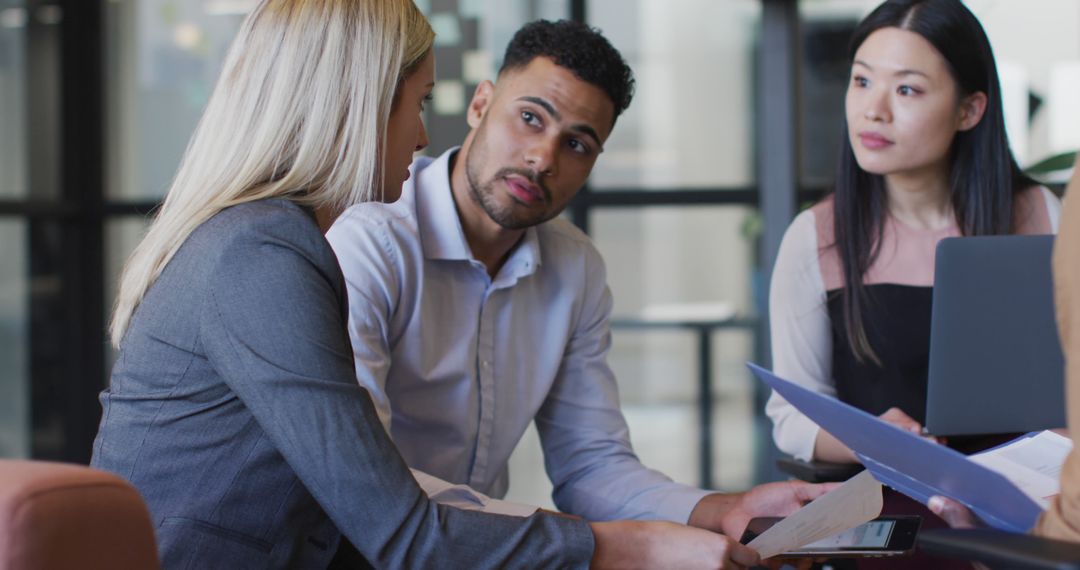 Diverse Business Team Engaged in Office Discussion