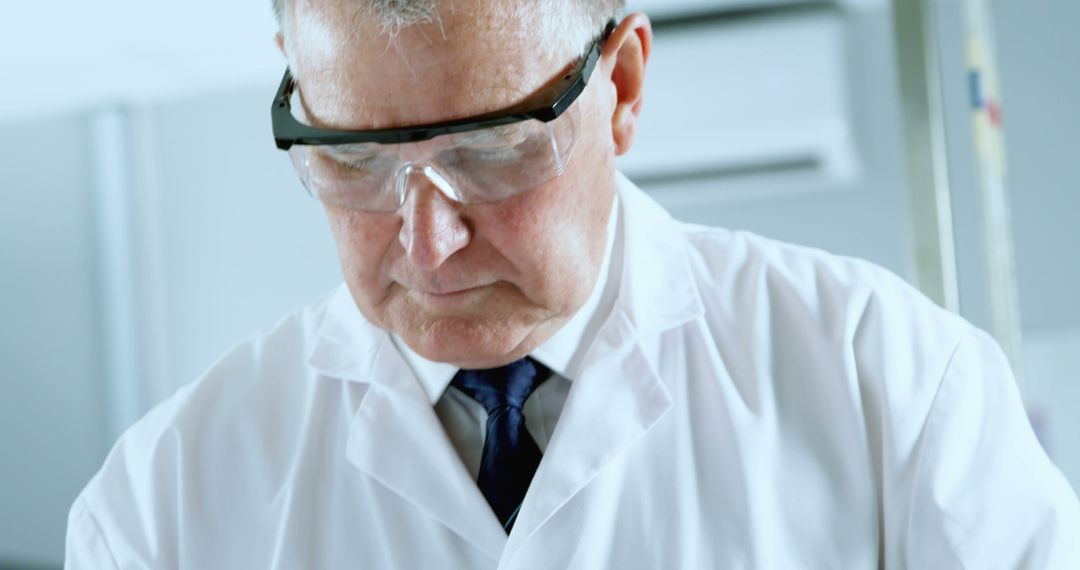 Senior Scientist Wearing Protective Goggles in Laboratory - Free Images, Stock Photos and Pictures on Pikwizard.com