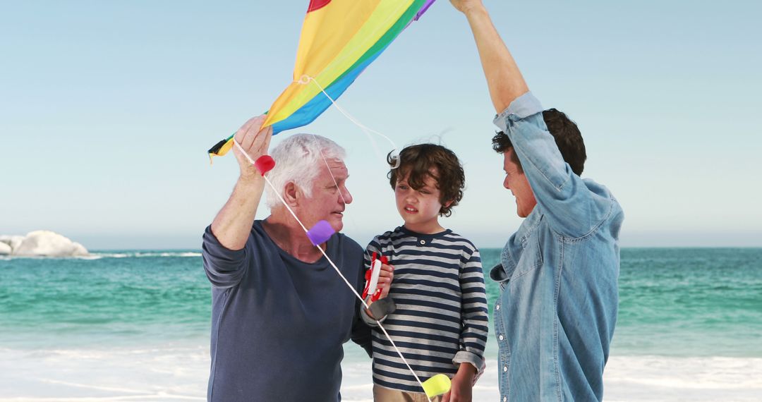 Grandfather, Father, and Son Flying Colorful Kite on Beach - Free Images, Stock Photos and Pictures on Pikwizard.com