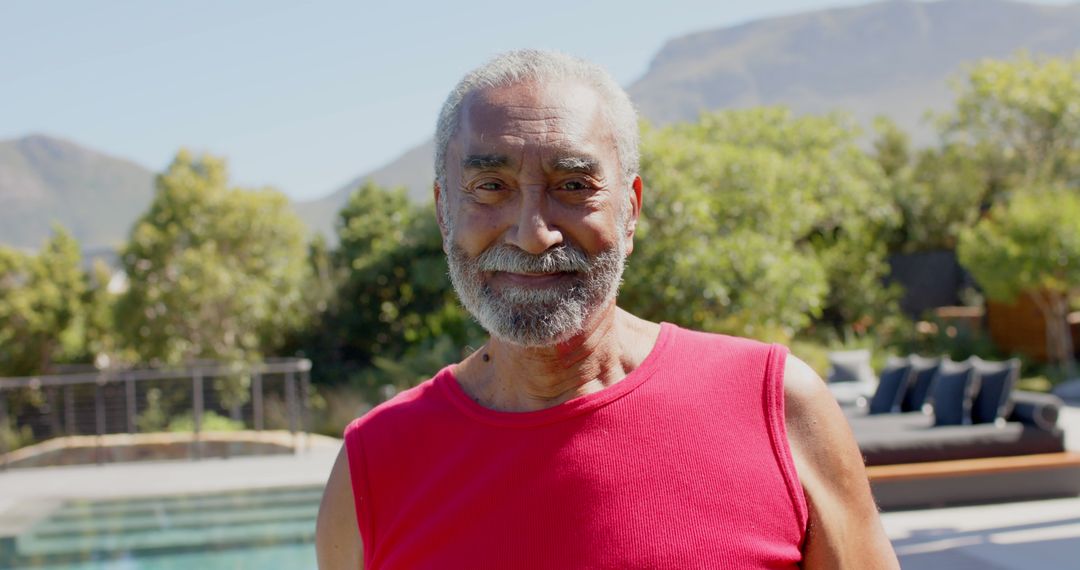 Happy Elderly Man Smiling Outdoors Near Pool On A Sunny Day - Free Images, Stock Photos and Pictures on Pikwizard.com