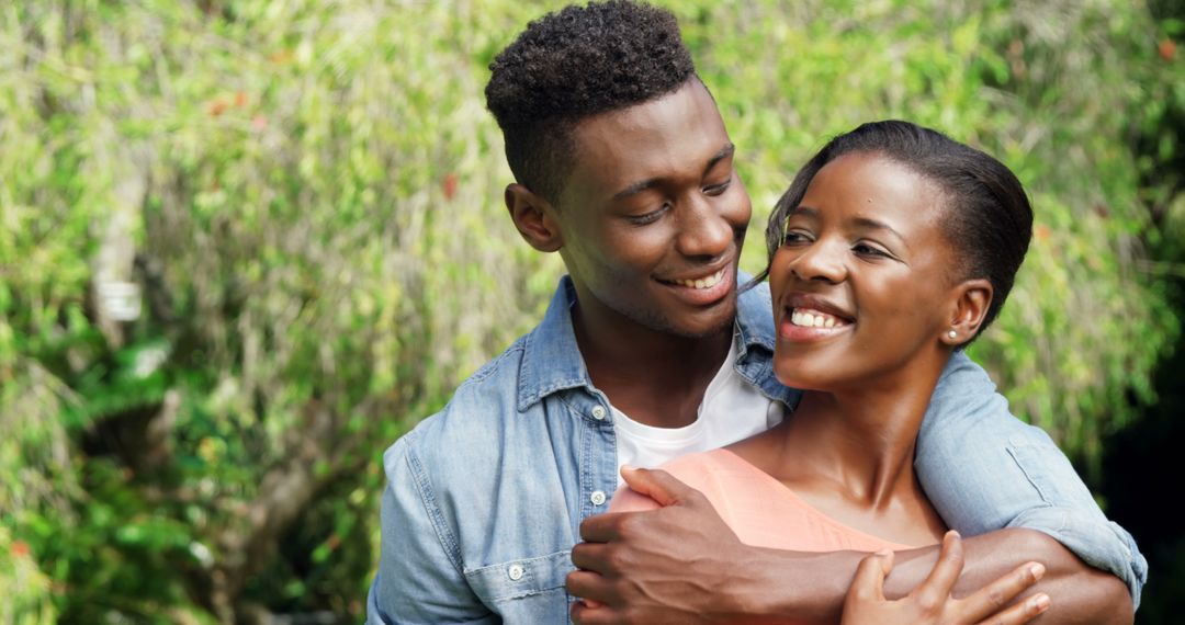 Happy Couple Embracing Outdoors with Romantic Smiles