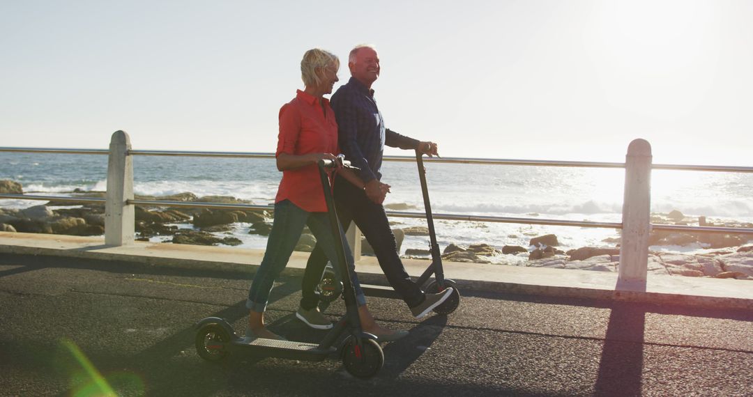 Senior Couple Riding Electric Scooters by Ocean - Free Images, Stock Photos and Pictures on Pikwizard.com