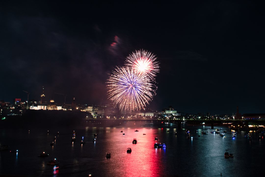 Spectacular Firework Display Over River at Night