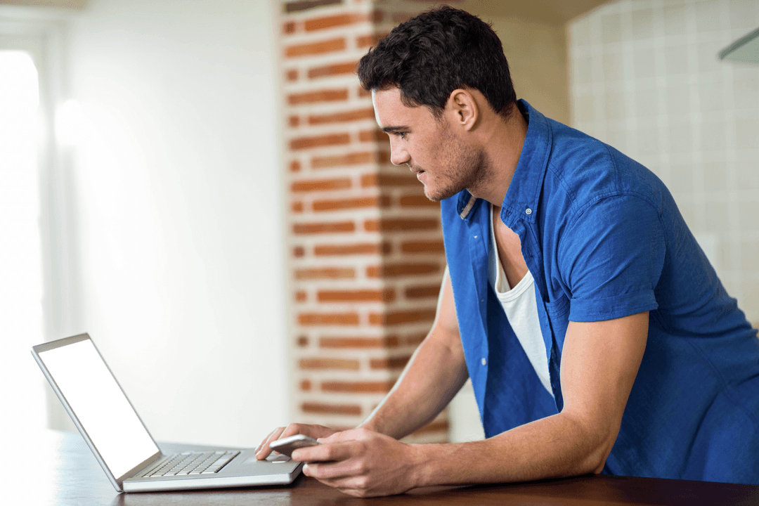 Transparent Screen Mockup of Man Using Laptop at Home
