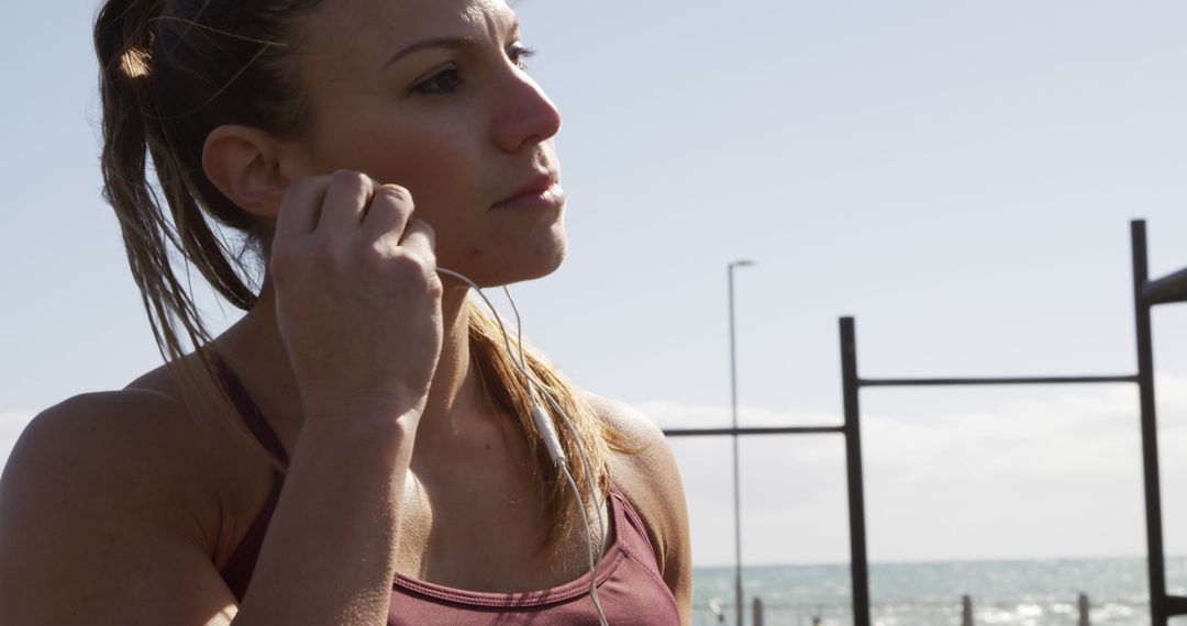 Fit Female Athlete Listening to Music During Outdoor Workout - Free Images, Stock Photos and Pictures on Pikwizard.com