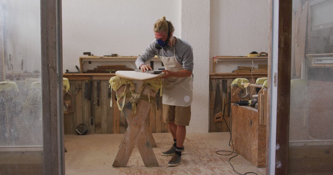 Craftsman Polishing Surfboard in Workshop - Free Images, Stock Photos and Pictures on Pikwizard.com