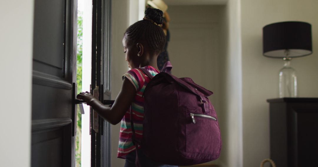 Image of happy african american girl with schoolbag opening front door and leaving home for school - Free Images, Stock Photos and Pictures on Pikwizard.com