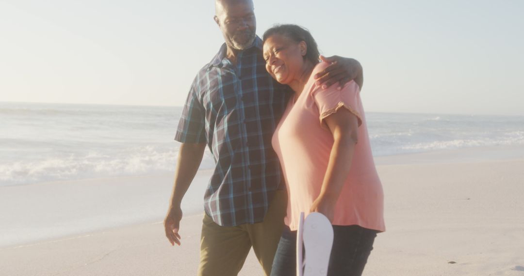 Smiling Mature African American Couple Walking on the Beach Together - Free Images, Stock Photos and Pictures on Pikwizard.com