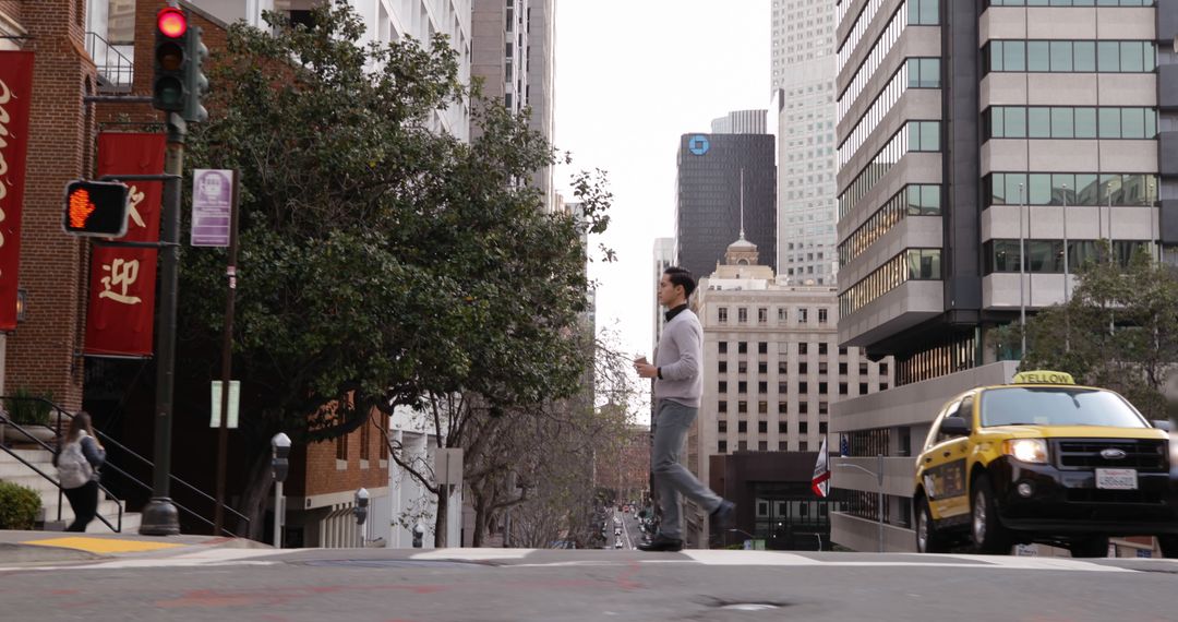 Person Walking in Urban City Street Intersection with Taxi and Skyscrapers - Free Images, Stock Photos and Pictures on Pikwizard.com