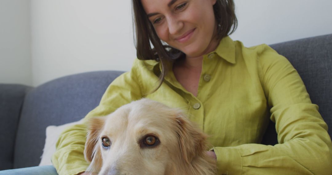 Smiling Woman Petting Relaxed Dog on Couch at Home - Free Images, Stock Photos and Pictures on Pikwizard.com