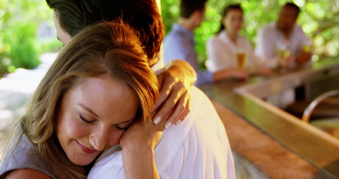 Happy Couple Embracing at Vibrant Outdoor Restaurant - Free Images, Stock Photos and Pictures on Pikwizard.com