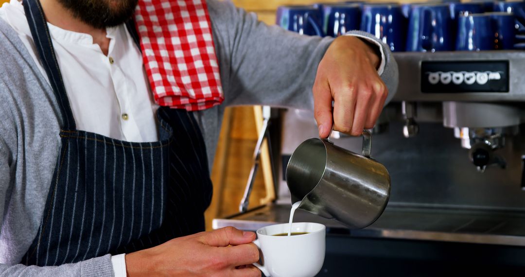 Barista Pouring Milk into Freshly Brewed Coffee at Coffee Shop - Free Images, Stock Photos and Pictures on Pikwizard.com