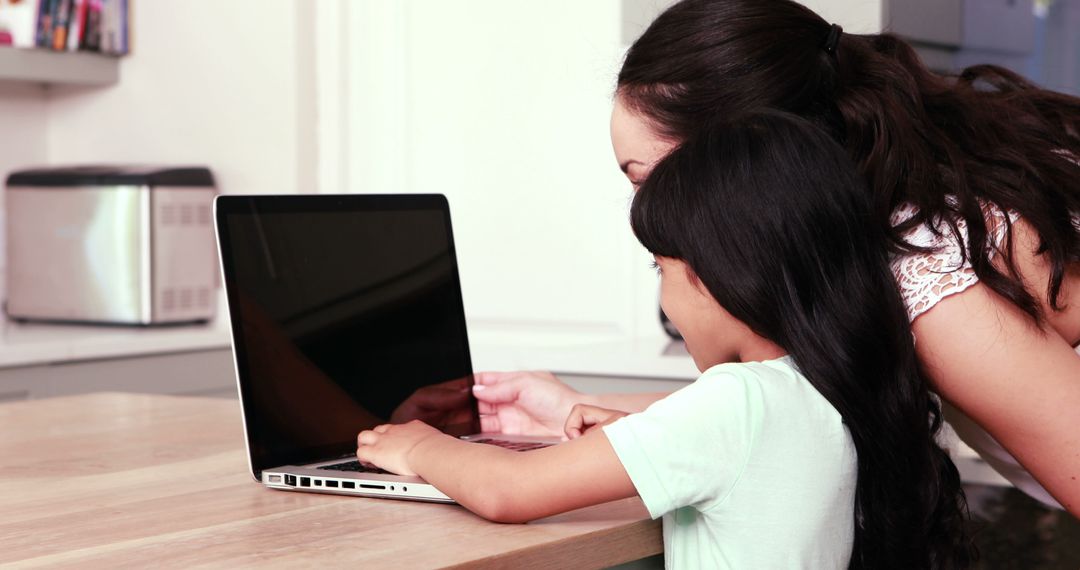 Mother and Daughter Learning Together on Laptop in Modern Kitchen - Free Images, Stock Photos and Pictures on Pikwizard.com