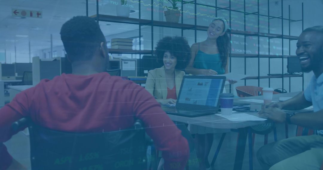 Diverse Team Collaborating Excitedly Around Office Table