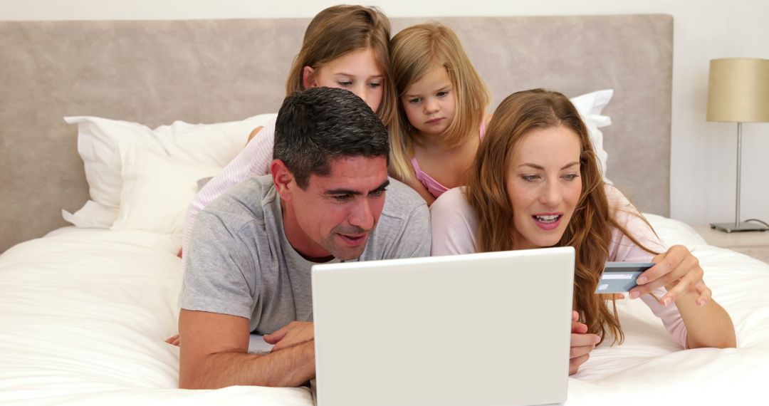 Family Shopping Online Together on Bed Using Credit Card - Free Images, Stock Photos and Pictures on Pikwizard.com