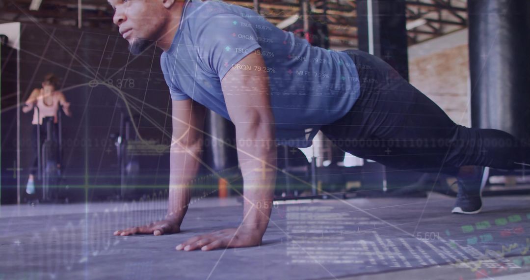 Man Performing Push-Ups in Gym with Digital Graph Overlays