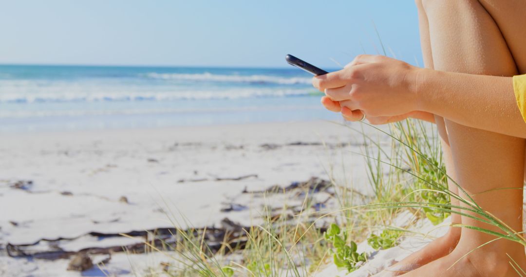 Close-Up of Person Using Smartphone on Beach - Free Images, Stock Photos and Pictures on Pikwizard.com