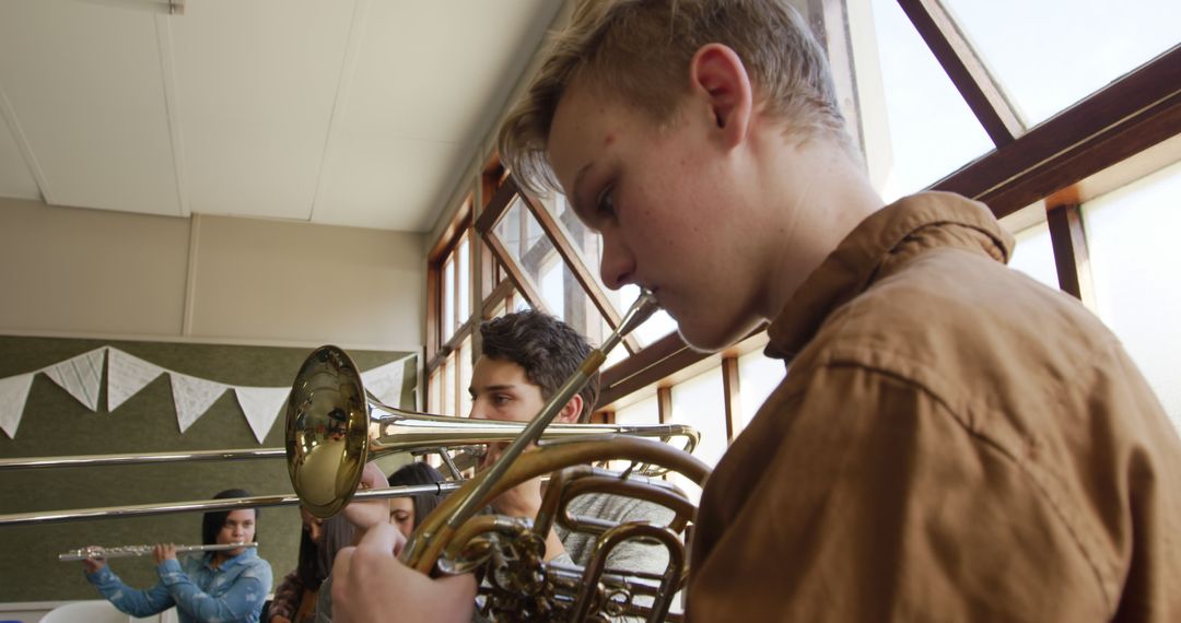 Teenage Brass Quartet Practicing in Bright Classroom - Free Images, Stock Photos and Pictures on Pikwizard.com