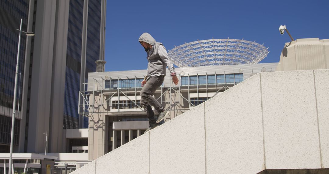 Urban Freerunner Wearing Hoodie Balancing on Concrete - Free Images, Stock Photos and Pictures on Pikwizard.com