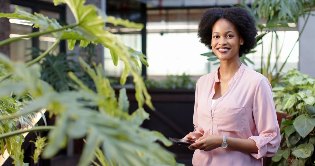 Confident Businesswoman Utilizing Technology Among Lush Greenery