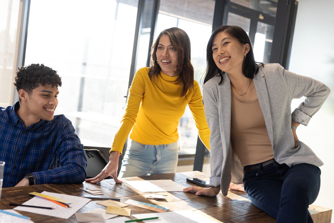 Diverse Team Brainstorming in Modern Office with Prototypes