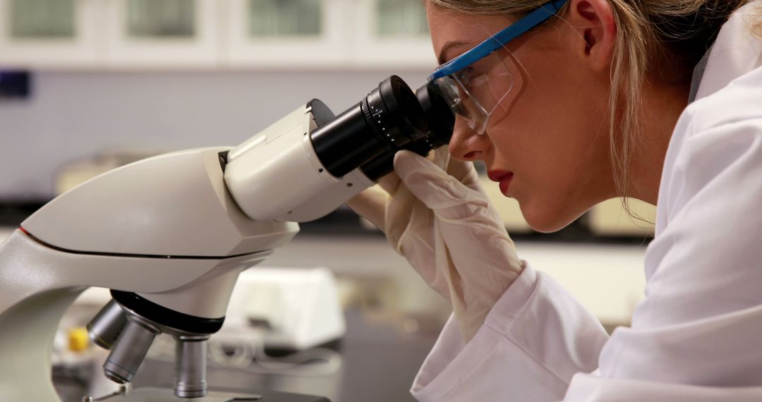 Female Scientist Examining Samples With Microscope in Laboratory - Free Images, Stock Photos and Pictures on Pikwizard.com