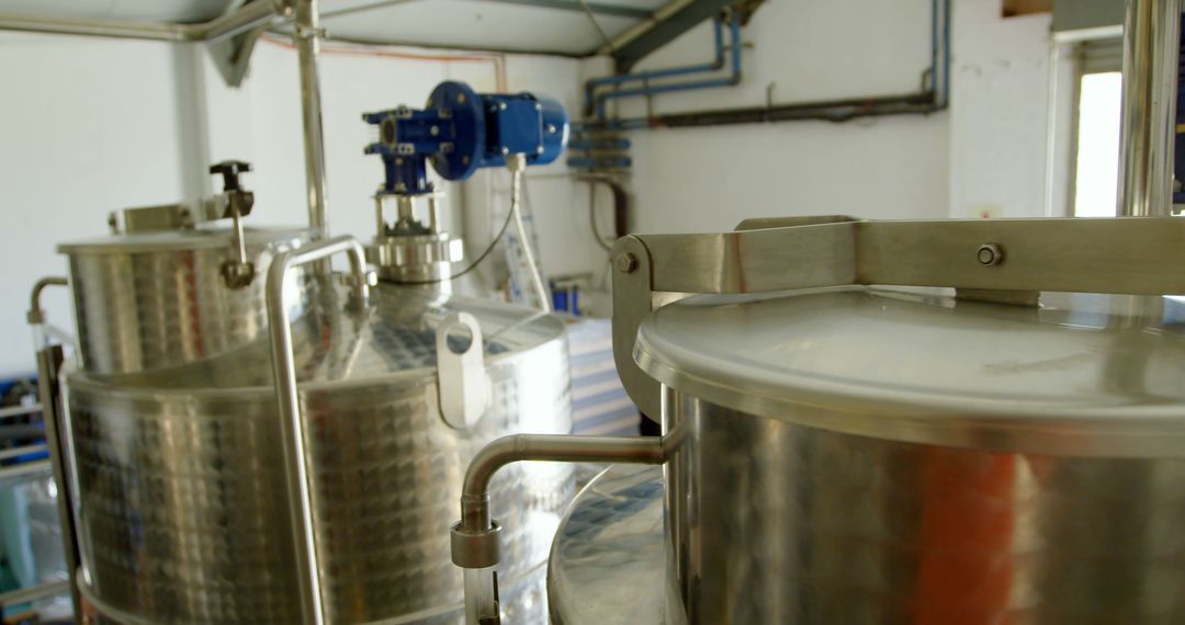 Interior of modern brewery with stainless steel tanks - Free Images, Stock Photos and Pictures on Pikwizard.com