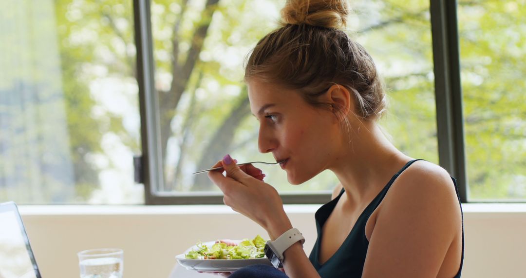 Young Woman Eating Healthy Breakfast in Bright Room - Free Images, Stock Photos and Pictures on Pikwizard.com