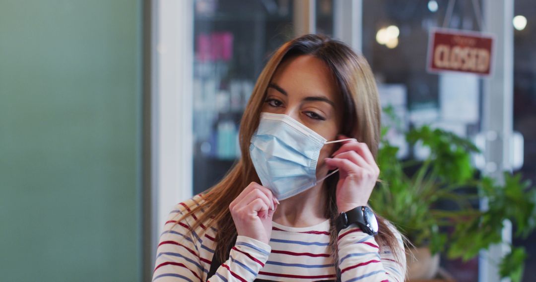 Woman Wearing Mask in an Indoor Environment with Closed Sign - Free Images, Stock Photos and Pictures on Pikwizard.com