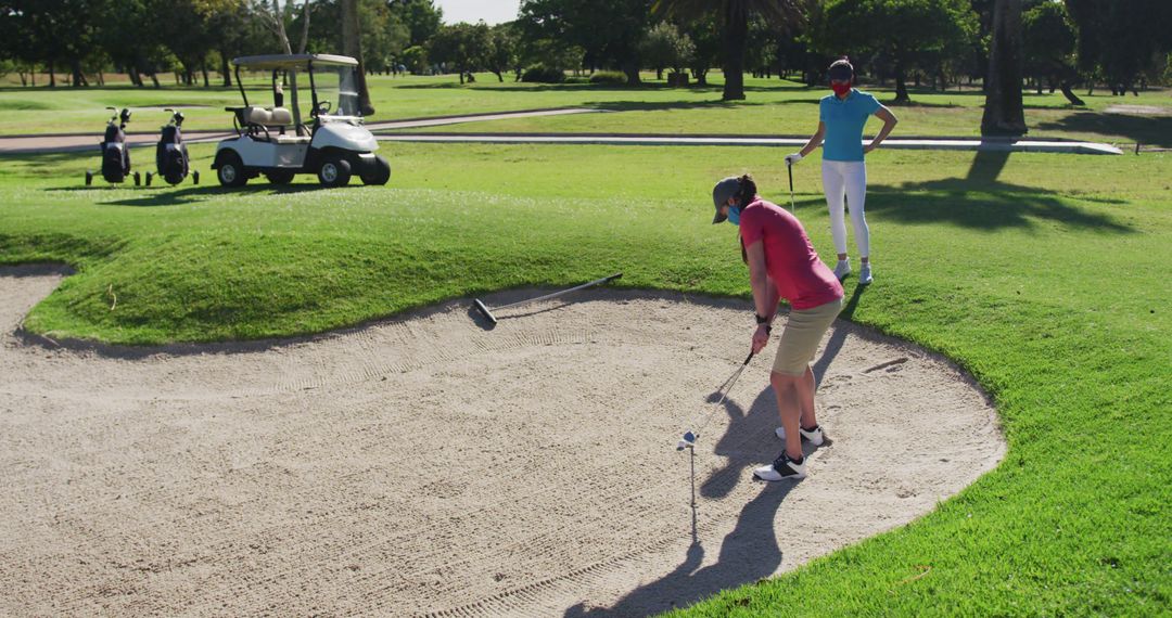 Caucasian Women Playing Golf with Face Masks for Safety
