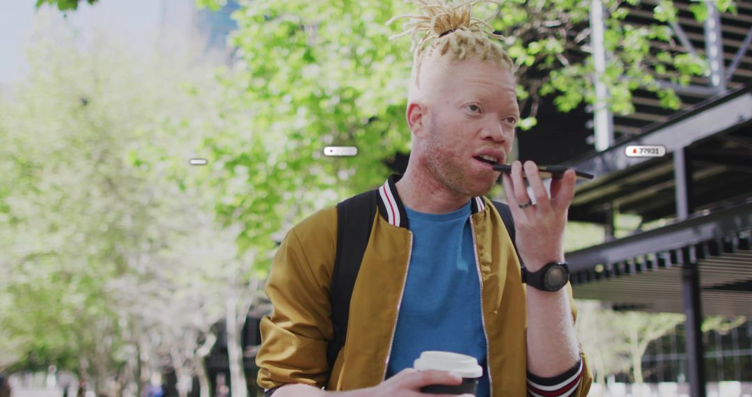 Albino Man Using Voice Command on Smartphone and Holding Coffee in Urban Environment