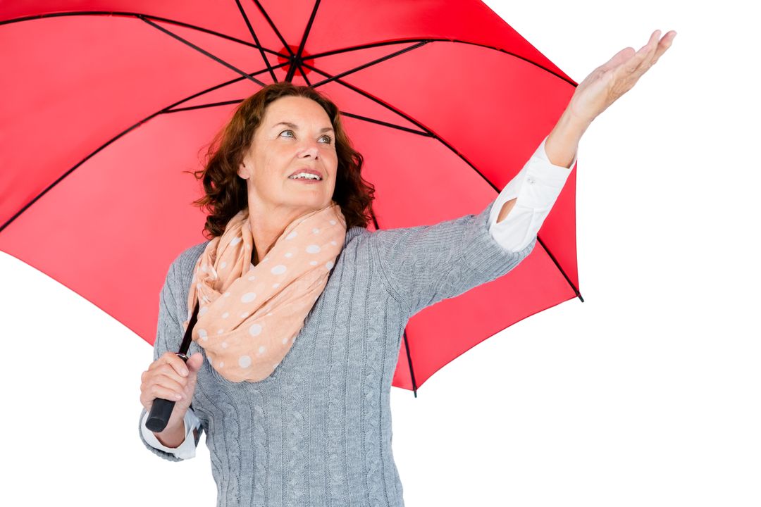 Mature woman holding red umbrella - Free Images, Stock Photos and Pictures on Pikwizard.com