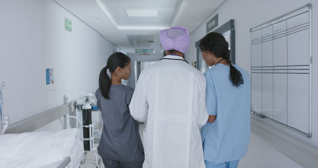 Medical Team Walking Through Hospital Corridor - Free Images, Stock Photos and Pictures on Pikwizard.com