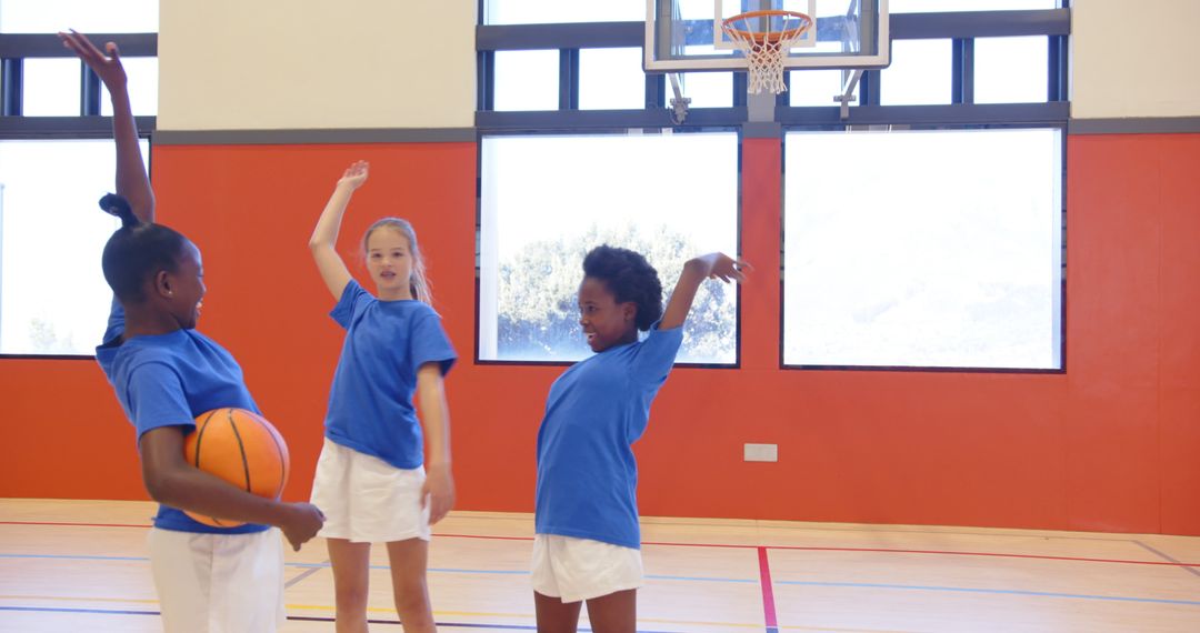 Youth Basketball Team Celebrating Enthusiastically in Gymnasium