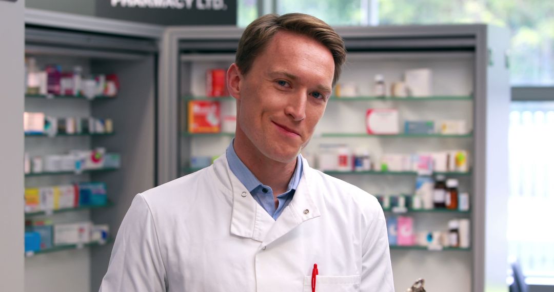 Confident Male Pharmacist in White Coat at Pharmacy Counter - Free Images, Stock Photos and Pictures on Pikwizard.com