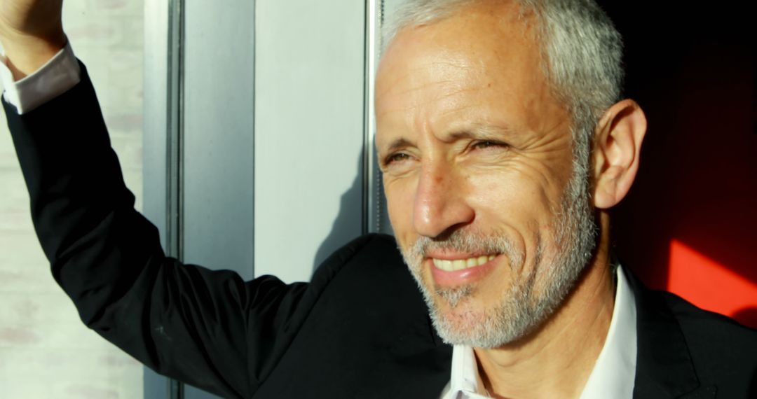 Mature Gray-Haired Man Smiling in Sunlight Near Window - Free Images, Stock Photos and Pictures on Pikwizard.com