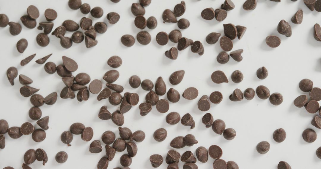 Overhead View of Chocolate Chips on White Background – Fusion Food and Sweets Concept - Free Images, Stock Photos and Pictures on Pikwizard.com