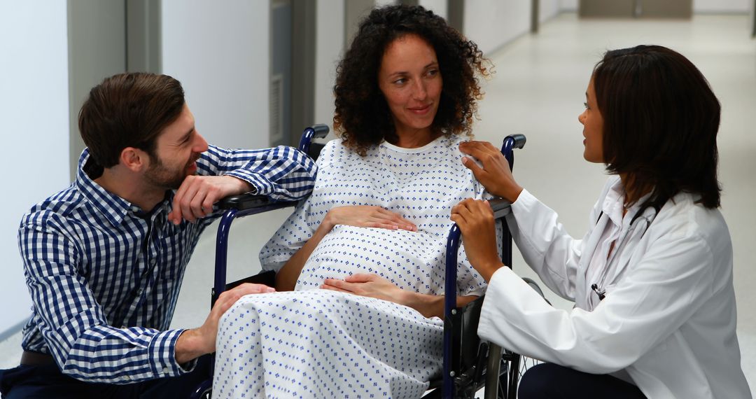 Pregnant woman in wheelchair with supportive partner talking to doctor - Free Images, Stock Photos and Pictures on Pikwizard.com