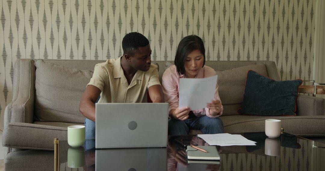 Diverse Team Collaborating on Documents in Modern Living Room