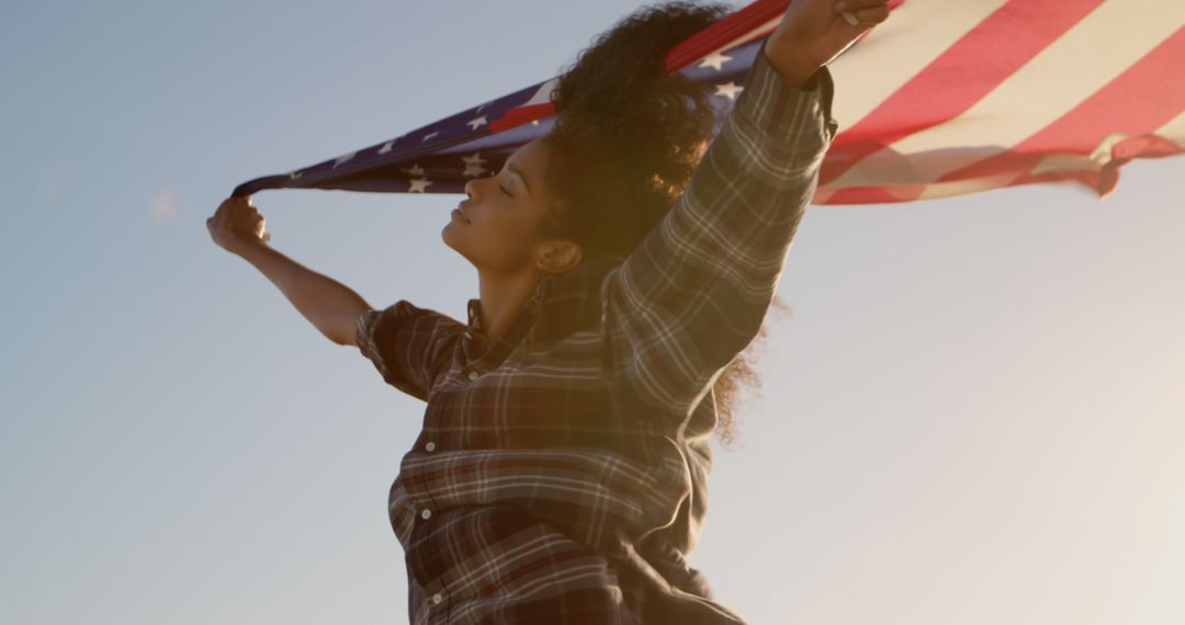 Young Woman Celebrating Freedom with American Flag in Sunlight - Free Images, Stock Photos and Pictures on Pikwizard.com