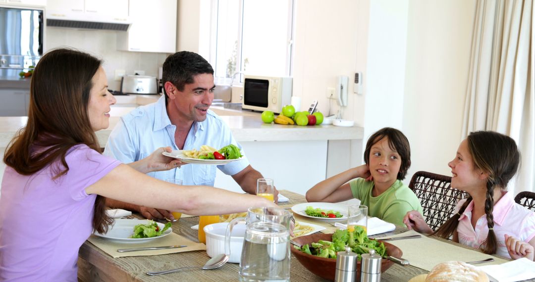 Happy Family Enjoying Healthy Meal Together in Modern Kitchen - Free Images, Stock Photos and Pictures on Pikwizard.com