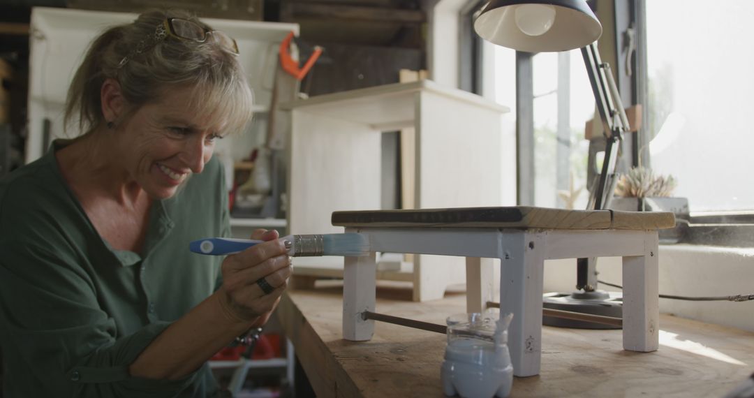 Woman Painting Wooden Furniture in Workshop - Free Images, Stock Photos and Pictures on Pikwizard.com