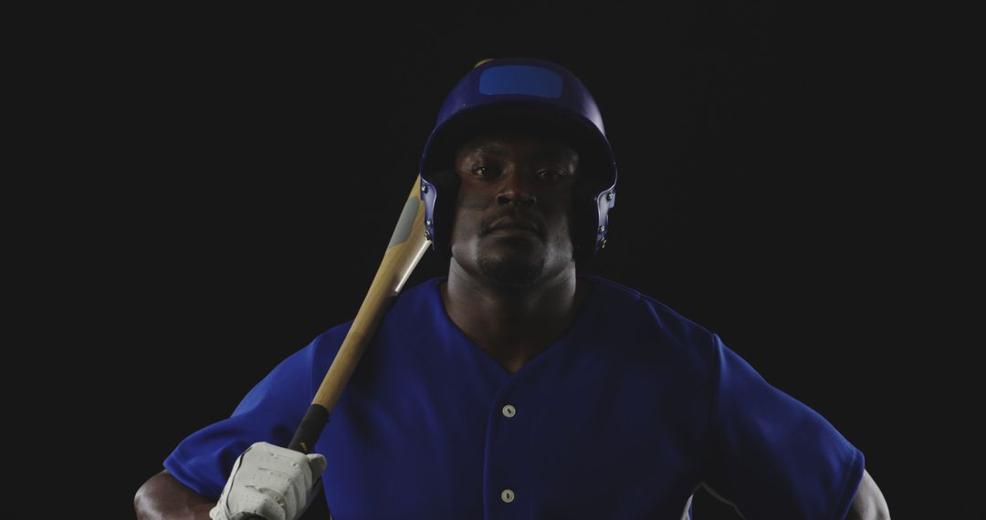 Baseball Player in Full Gear with Bat on Shoulder in Dark Studio - Free Images, Stock Photos and Pictures on Pikwizard.com