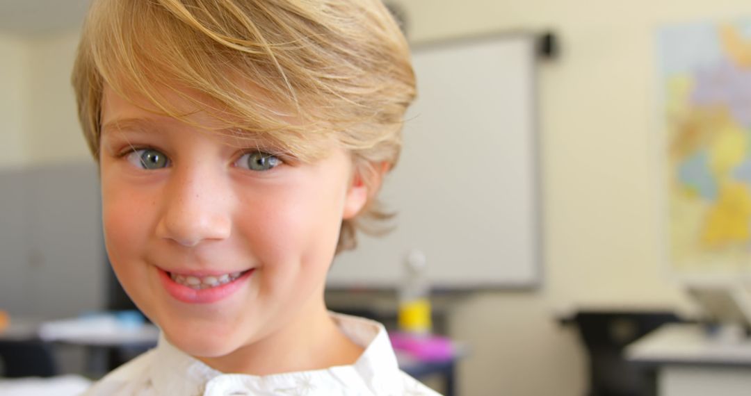Cheerful Schoolboy Smiling in Classroom