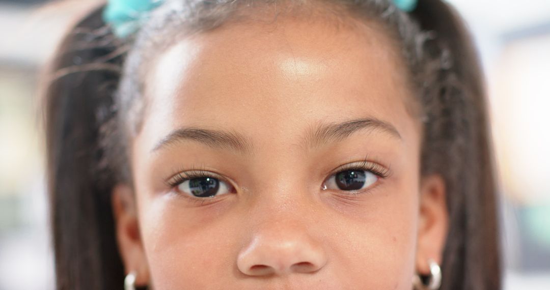 Close-Up of Schoolgirl with Pigtails Looking at Camera