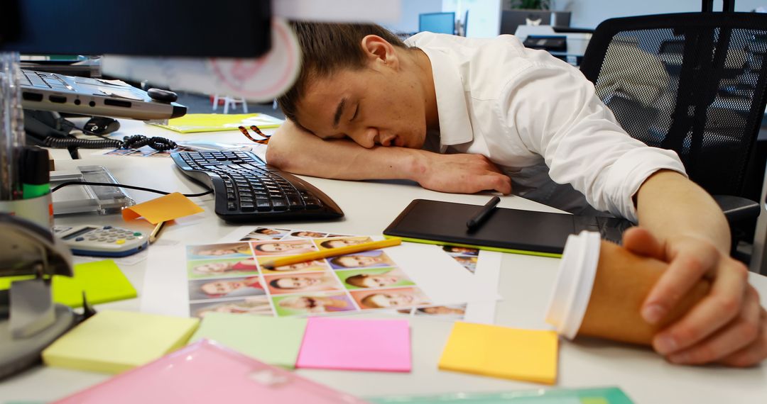 Exhausted Employee Sleeping at Desk with Coffee and Sticky Notes - Free Images, Stock Photos and Pictures on Pikwizard.com