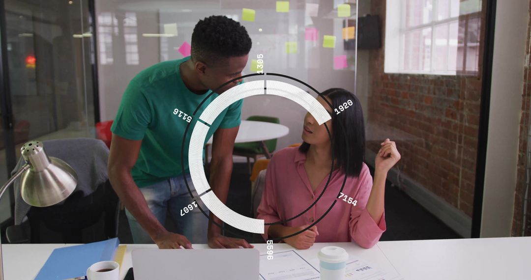 Young Professionals Collaborating in Modern Office with Data Visualization