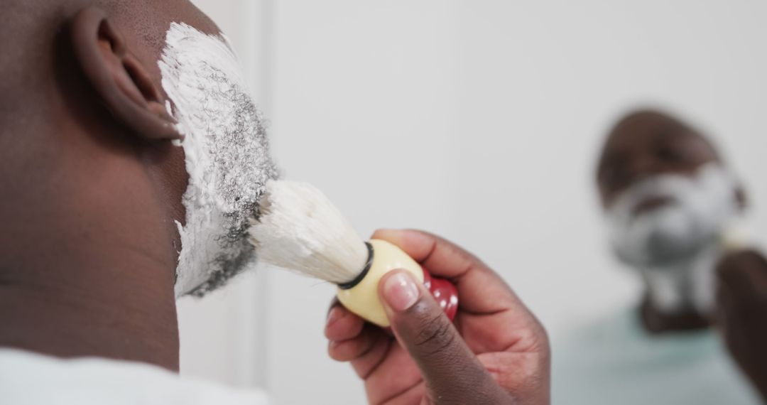 Man Applying Shaving Cream with Brush on Beard in Mirror - Free Images, Stock Photos and Pictures on Pikwizard.com