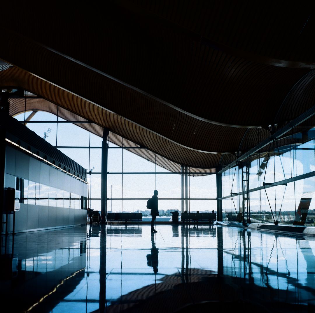 Traveler Walking Through Modern Airport Terminal With Architectural Design